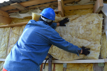 Builder  insulating wooden house with mineral  wool
