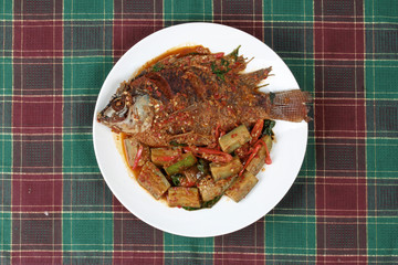 Deep-fried tilapia fish topped Spicy fried eggplant.