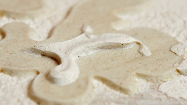 Texture of working Stucco pattern white color wall. Multi-layer decorative plaster plaster. Macro shot with moving camera