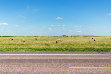 A road cutting through northern Nebraska on a summer day. 