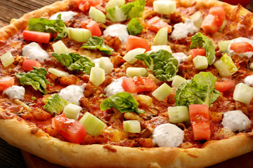 Fresh homemade pizza with chicken and garlic sauce on wooden bac