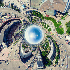 Aerial city view with crossroads and roads, houses, buildings, parks and parking lots, bridges. Urban landscape. Copter shot. Panoramic image.
