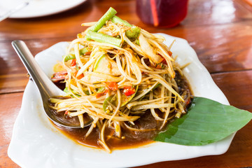 Raw papaya salad well  known in thai is SOM-TAM
