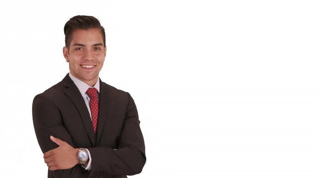 Happy smiling young Hispanic business professional standing on white background with copy space. Crossed arms Portrait of Latino businessman in suit and tie on solid backdrop with copyspace for text