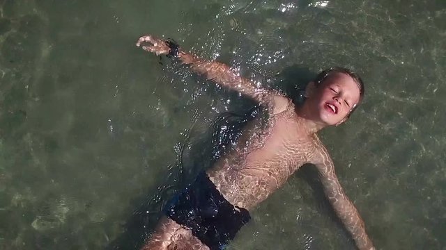 Little boy enjoying time in the water, slow motion