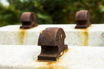 Concrete beams with rusty metal for railway tracks