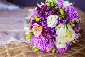 Wedding bride accessories on a  background: bridal bouquet of white and purple roses.