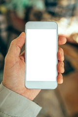 Male hand holding white smartphone with blank screen