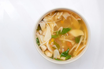 Hot and Spicy Soup with mushroom, mix vegetable and Thai herbs in white bowl on white background ,Vegetarian Food, Healthy food