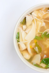 Hot and Spicy Soup with mushroom, mix vegetable and Thai herbs in white bowl on white background ,Vegetarian Food, Healthy food