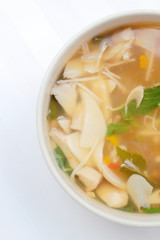 Hot and Spicy Soup with mushroom, mix vegetable and Thai herbs in white bowl on white background ,Vegetarian Food, Healthy food