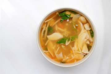 Hot and Spicy Soup with mushroom, mix vegetable and Thai herbs in white bowl on white background ,Vegetarian Food, Healthy food