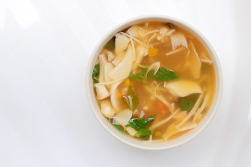 Hot and Spicy Soup with mushroom, mix vegetable and Thai herbs in white bowl on white background ,Vegetarian Food, Healthy food