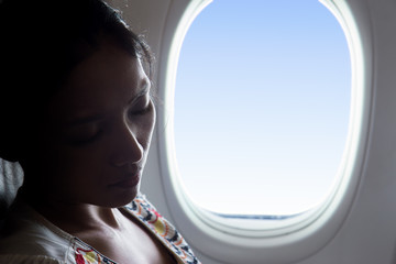 portrait of woman sleeping in an airplane