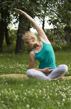 Flexible young woman is engaged in yoga