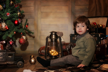 night before Christmas little baby sitting on the floor and play