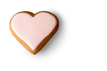 Cookie in shape of heart. Brown biscuit with pink glaze. Small romantic dessert. Symbol of love.
