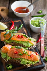 Whole grain bread with avocado paste and salmon