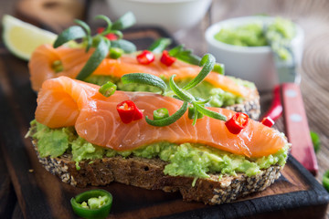 Whole grain bread with avocado paste and salmon