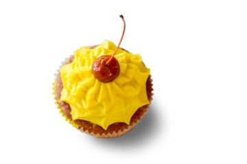 Top view of cupcake. Cherry on yellow cream. Good appetite and mood. Make your day brighter.
