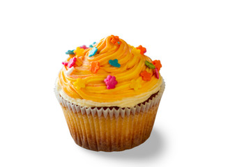 Cupcake with orange cream. Small decorated cake. Eat a dessert at cafe. Charge of energy and mood.