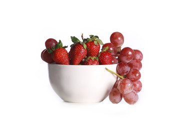 a bowl with strawberry and grapes