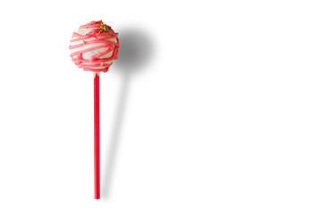 Pink cake pop. Icing and sprinkles. Dessert with raspberry taste. Sponge cake and white chocolate.