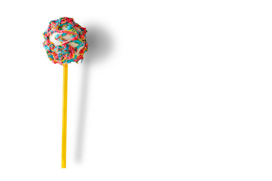 Cake pop with sprinkles. Candy on white background. Eat well and have fun. Boost your mood.
