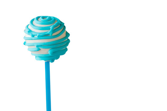 Candy on white background. Cake pop with blue icing. Tasty dessert with soft filling. Relax and enjoy the flavor.