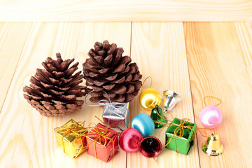 christmas gifts decoration and pine cones on the wooden background.