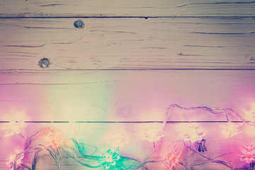 christmas light and christmas decoration on wood background with