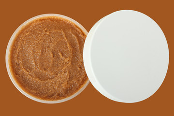 Body scrub. Jar of honey sugar peeling. 