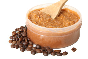 Body scrub of ground coffee  in jar on white isolated background. Homemade cosmetic for peeling and spa care.