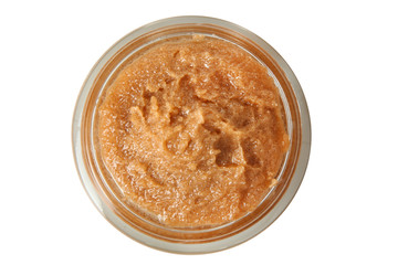 Body scrub of ground coffee and sugar in jar on white isolated background. Homemade cosmetic for peeling and spa care. Top view.