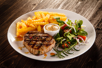 Grilled steak, French fries and vegetables
