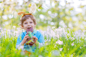Little kid with Easter bunny ears and chocolate