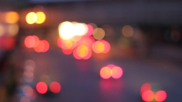 Abstract circular bokeh motion lens blur backround of city and street light on rainy day at night time in Thaialnd