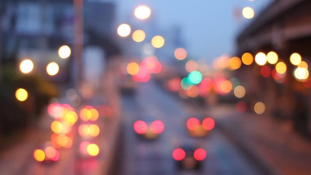 Abstract circular bokeh motion lens blur backround of city and street light on rainy day at night time in Thaialnd