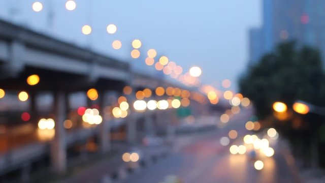 Abstract circular bokeh motion lens blur backround of city and street light on rainy day at night time in Thaialnd
