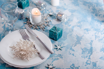 Fototapeta na wymiar Silver and cream Christmas Table Setting with decorations