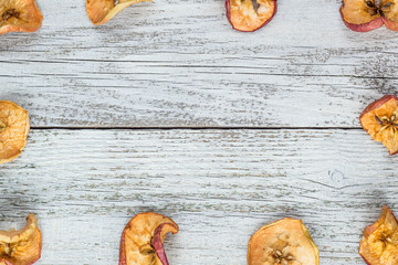 Dried apple slices on wooden table