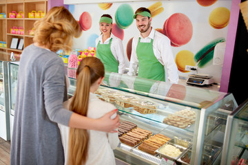 Mother with daughter in pastry shop