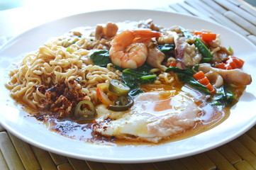 instant noodle dressing seafood gravy sauce and creamy egg yolk on dish