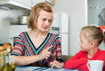 Young woman preaching little daughter