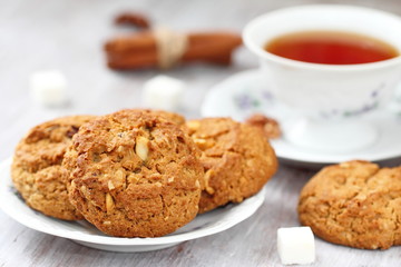 Cup of tea and oatmeal cookies with nuts, raisins  cinnamon