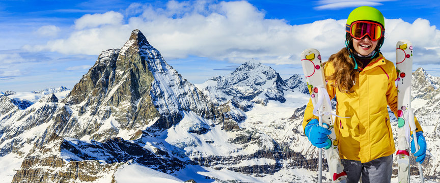 Teenage girl skiing in Swiss Alps in Sunny Day, Matterhorn in Ba