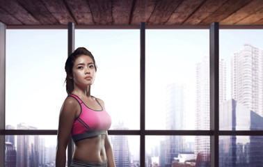 Beautiful asian woman practicing with city buildings view