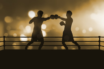 Silhouette of two professional asian boxer fight in the boxing match