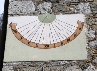 Sundial with Roman numerals marking the hours with the shadow of