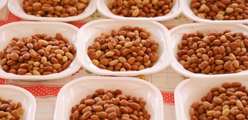 plastic plates with boiled beans on the table during the party